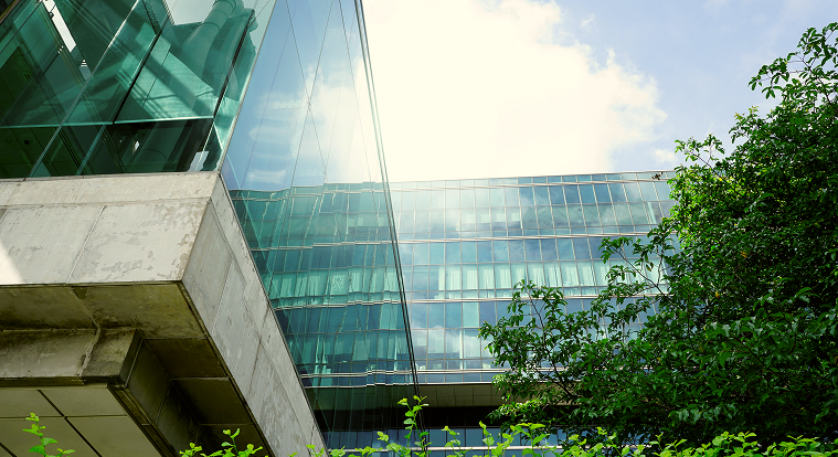 A glass office building, representing tokenized real world assets